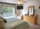 Bright bedroom with balcony access, and dresser with mirror at 4602 Cumbrian Lakes Dr, Kissimmee, FL 34746