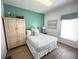 Comfortable bedroom featuring neutral tones, wood-look floors and an armoire for extra storage at 4602 Cumbrian Lakes Dr, Kissimmee, FL 34746