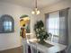 Cozy dining area with white furniture, a window, and a view into the kitchen at 4602 Cumbrian Lakes Dr, Kissimmee, FL 34746