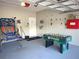 Entertaining garage area, complete with foosball, basketball hoop and plenty of wall decor at 4602 Cumbrian Lakes Dr, Kissimmee, FL 34746