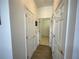 Hallway featuring wood-look floors, light-colored walls, and several doors leading to other rooms at 4602 Cumbrian Lakes Dr, Kissimmee, FL 34746