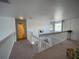 Upstairs hallway featuring railing and chandelier at 4602 Cumbrian Lakes Dr, Kissimmee, FL 34746