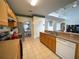 Functional kitchen with stainless steel appliances, wood cabinets, and an open layout to the dining room at 4602 Cumbrian Lakes Dr, Kissimmee, FL 34746