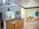 Bright kitchen featuring a breakfast bar, tile floors, stainless steel sink and a dining area with outdoor access at 4602 Cumbrian Lakes Dr, Kissimmee, FL 34746