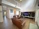 Spacious living room boasts a two-story ceiling, hardwood floors, and comfortable leather couches at 4602 Cumbrian Lakes Dr, Kissimmee, FL 34746
