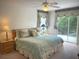 Inviting main bedroom with ceiling fan, balcony access, and soft natural light at 4602 Cumbrian Lakes Dr, Kissimmee, FL 34746