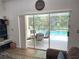 View of a patio set and pool through the sliding glass doors of the home at 4602 Cumbrian Lakes Dr, Kissimmee, FL 34746