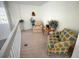Cozy upstairs sitting area with armchairs, plants, and view at 4602 Cumbrian Lakes Dr, Kissimmee, FL 34746