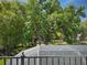A tree-filled backyard beyond the screened enclosure at 4602 Cumbrian Lakes Dr, Kissimmee, FL 34746