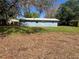 View of the backyard from mulch area featuring blue home at 4625 Weston Rd, Bartow, FL 33830