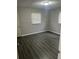 This bedroom has gray walls, white trim, and dark vinyl flooring at 4625 Weston Rd, Bartow, FL 33830