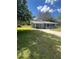 Charming single-story house featuring a carport, screened-in porch, and spacious yard at 4625 Weston Rd, Bartow, FL 33830