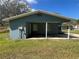 The exterior of a single-story home with a carport and view of the screened-in porch at 4625 Weston Rd, Bartow, FL 33830