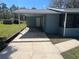 Exterior view of a home, showcasing the carport, screened-in porch, and block construction at 4625 Weston Rd, Bartow, FL 33830
