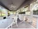Community BBQ area featuring a stone grill and covered seating with ceiling fans at 5364 Diplomat Ct # 106, Kissimmee, FL 34746