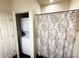 Bathroom featuring a shower/tub combination with a decorative shower curtain and stacked washer/dryer at 5364 Diplomat Ct # 106, Kissimmee, FL 34746