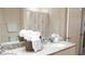 Bright bathroom features granite countertops, double sinks, and shower with a decorative shower curtain at 5364 Diplomat Ct # 106, Kissimmee, FL 34746