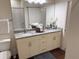Bright bathroom features granite countertops, double sinks, and luxury vinyl flooring at 5364 Diplomat Ct # 106, Kissimmee, FL 34746