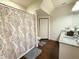 Bright bathroom features a granite-topped vanity and tub-shower combo with patterned curtain at 5364 Diplomat Ct # 106, Kissimmee, FL 34746