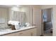 Bathroom featuring a double vanity with granite countertop leading to the main bedroom at 5364 Diplomat Ct # 106, Kissimmee, FL 34746