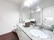 Bright bathroom featuring a double vanity with granite countertop and modern fixtures at 5364 Diplomat Ct # 106, Kissimmee, FL 34746