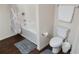 Bright bathroom features a shower/bathtub combo, a white toilet, and a decorative shower curtain at 5364 Diplomat Ct # 106, Kissimmee, FL 34746