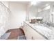 Bright bathroom with granite countertops, double sinks, and decorative shower curtain at 5364 Diplomat Ct # 106, Kissimmee, FL 34746