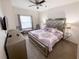 Bedroom with ceiling fan, large window and mirrored headboard on the bed at 5364 Diplomat Ct # 106, Kissimmee, FL 34746
