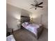 Bedroom featuring a bed with mirrored accents and a ceiling fan at 5364 Diplomat Ct # 106, Kissimmee, FL 34746