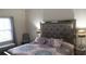 Comfortable bedroom with mirrored headboard, window seating, and soft decor at 5364 Diplomat Ct # 106, Kissimmee, FL 34746