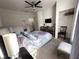 Bedroom with flat screen tv, ceiling fan, queen sized bed, and open closet at 5364 Diplomat Ct # 106, Kissimmee, FL 34746