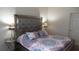 Bedroom featuring a mirrored headboard, patterned bedding, and stylish lamps at 5364 Diplomat Ct # 106, Kissimmee, FL 34746