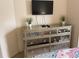 Bedroom featuring mirrored dresser with decorative plants and mounted TV at 5364 Diplomat Ct # 106, Kissimmee, FL 34746