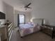 Cozy bedroom with ceiling fan, window with curtains, and modern dresser at 5364 Diplomat Ct # 106, Kissimmee, FL 34746