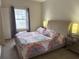 Bedroom with a plush bed, window with curtains, and bedside table at 5364 Diplomat Ct # 106, Kissimmee, FL 34746