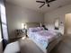Bedroom featuring a bed with colorful linens, ceiling fan, and natural light at 5364 Diplomat Ct # 106, Kissimmee, FL 34746