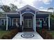 Exterior view of a new clubhouse with light blue siding and white columns at 5364 Diplomat Ct # 106, Kissimmee, FL 34746