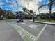 Community with a golf cart charging station near a blue clubhouse and pool at 5364 Diplomat Ct # 106, Kissimmee, FL 34746