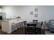A dining area with bar seating, a dining table with chairs, and a view into the living room at 5364 Diplomat Ct # 106, Kissimmee, FL 34746
