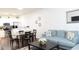 Open-concept living room with modern finishes, dining area, and a comfortable blue sofa at 5364 Diplomat Ct # 106, Kissimmee, FL 34746