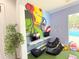 A vibrant playroom featuring superhero wall art, comfortable seating, and plenty of space for fun activities and games at 5364 Diplomat Ct # 106, Kissimmee, FL 34746