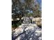 Backyard with a storage shed and chicken coop surrounded by lush greenery at 539 Libby Rd, Babson Park, FL 33827