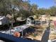 Large backyard with a greenhouse, storage shed, and raised garden beds at 539 Libby Rd, Babson Park, FL 33827