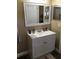 A vanity in a bathroom featuring a white frame mirror and bronze fixtures at 539 Libby Rd, Babson Park, FL 33827