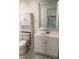 Updated bathroom features modern vanity, sleek sink, toilet, storage cabinet and a decorative mirror at 539 Libby Rd, Babson Park, FL 33827