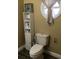 Bathroom featuring a toilet, round window, and a shelving unit at 539 Libby Rd, Babson Park, FL 33827