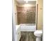 Cozy bathroom with a combination shower and tub, tile and glass shower door, vanity, and a toilet at 539 Libby Rd, Babson Park, FL 33827