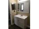 Bathroom featuring vanity with white cabinets, small sink, and mirror at 539 Libby Rd, Babson Park, FL 33827