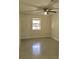 Well-lit bedroom features tile flooring and a ceiling fan for comfortable living at 539 Libby Rd, Babson Park, FL 33827