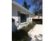 A white brick house with gray shutters and planters with flowers below the window at 539 Libby Rd, Babson Park, FL 33827
